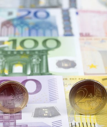 Euro coins on the background of banknotes